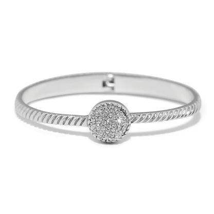 Brighton bangle bracelet with twisted silver-plated band and round crystal pavé centerpiece on a white background