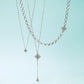 Brighton layered necklaces with silver-plated diamond-shaped pendants featuring crystal accents and varied chain styles on a white background