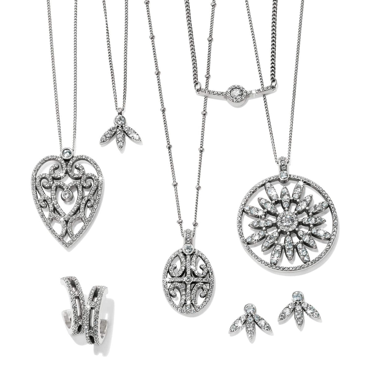 Brighton silver-plated jewelry set styled with crystal pendant necklaces and matching earrings on a white background