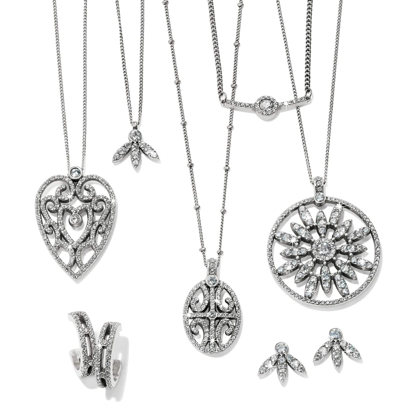 Brighton silver-plated jewelry set styled with crystal pendant necklaces and matching earrings on a white background