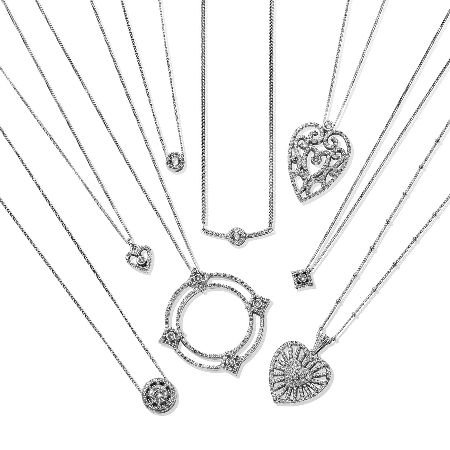 Brighton silver-plated pendant necklaces with crystal heart, circle, and geometric charms arranged in fan on a white background