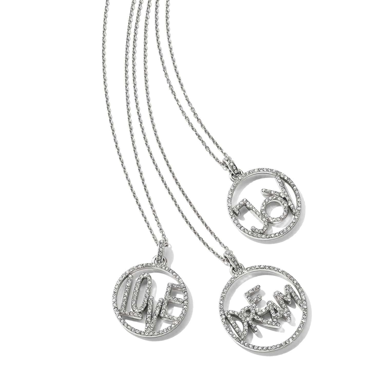 Brighton silver-plated pendant necklaces with crystal-covered Love, Joy, and Dream circle charms on a white background