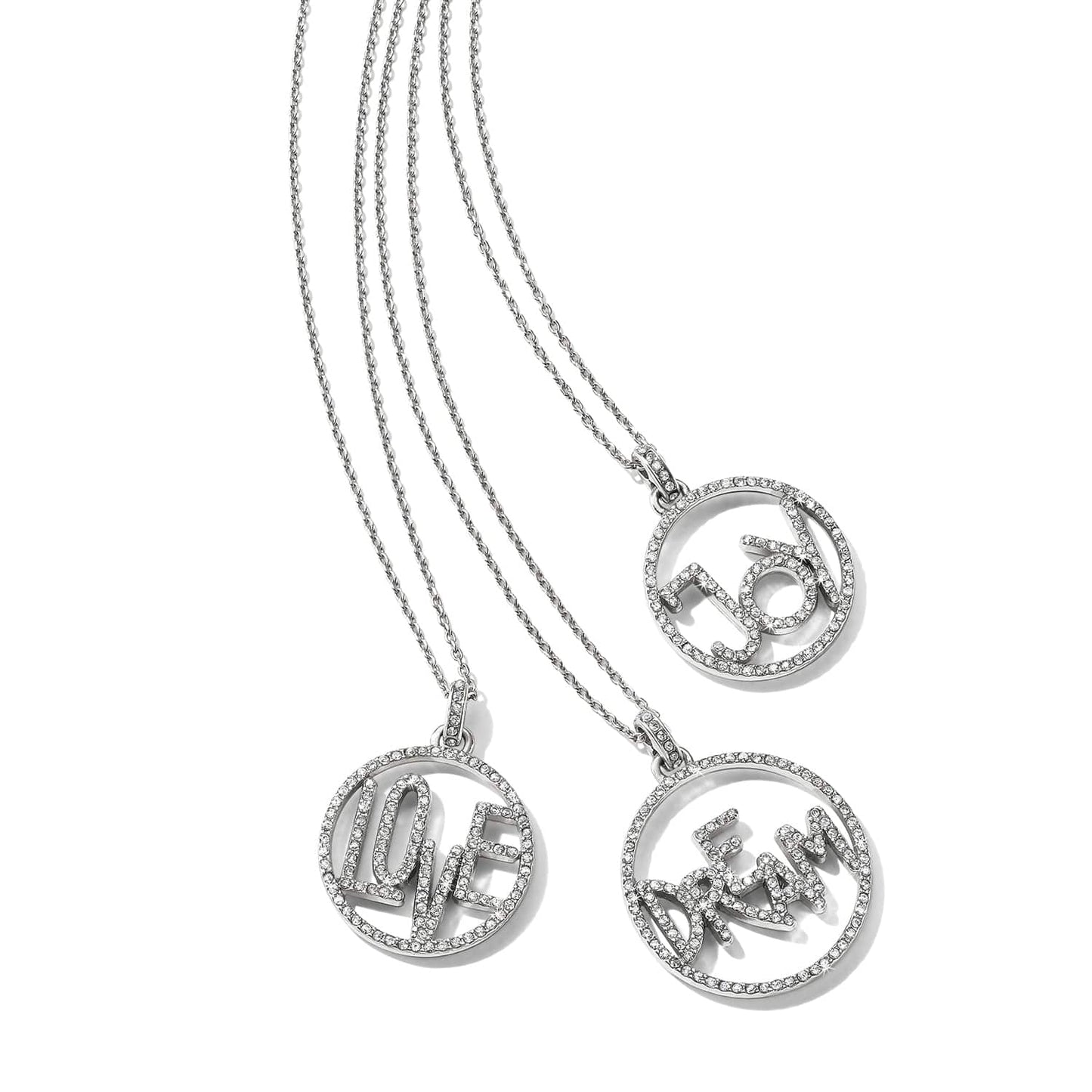 Brighton silver-plated pendant necklaces with crystal-covered Love, Joy, and Dream circle charms on a white background