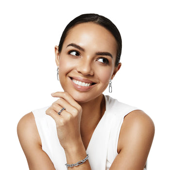 Model wearing Brighton silver-plated drop earrings with rectangular links, coordinating crystal ring, and chain link bracelet
