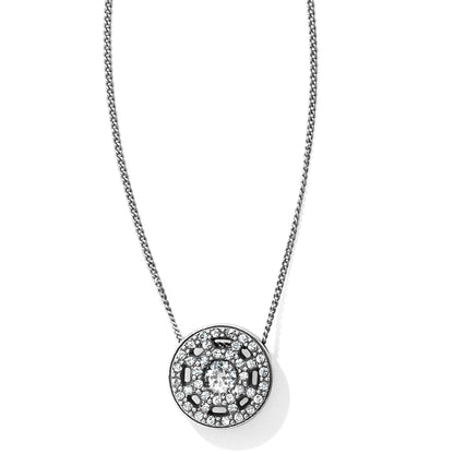 Brighton pendant necklace with silver-plated round medallion, crystal pave halo, and central crystal on a white background