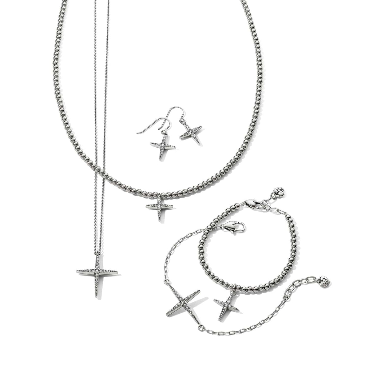Brighton silver-plated cross jewelry set styled with beaded necklace, bracelets, and drop earrings featuring crystal accents