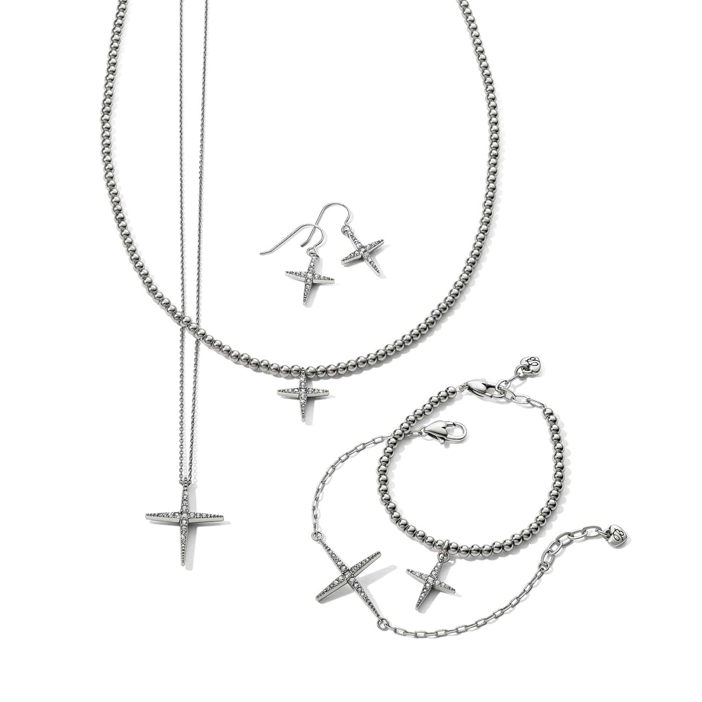 Brighton silver-plated cross jewelry set styled with beaded necklace, bracelets, and drop earrings featuring crystal accents