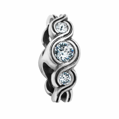 Brighton spacer charm with three round crystals set in silver-tone swirling scrollwork design on a white background