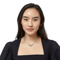 Model wearing a Brighton silver-plated necklace with curved crystal-accented centerpiece on a delicate chain