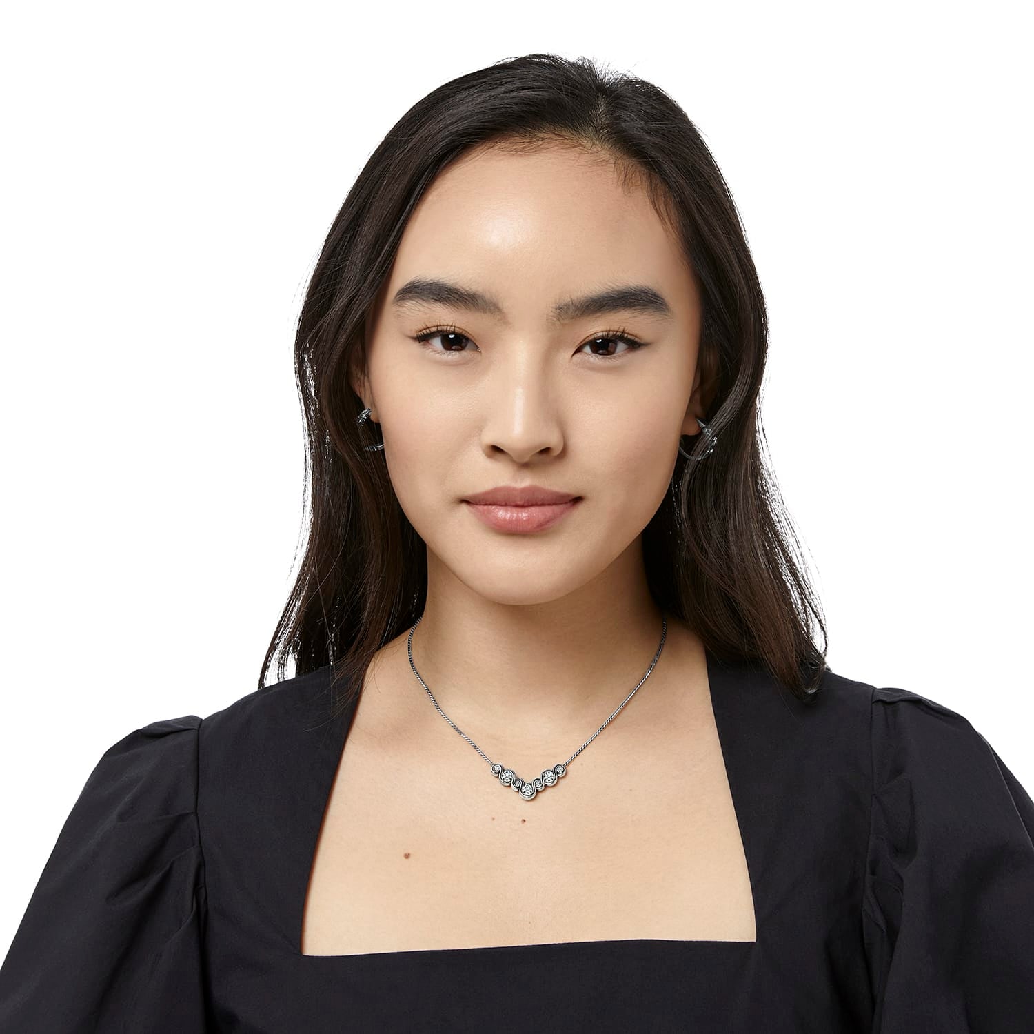 Model wearing a Brighton silver-plated necklace with curved crystal-accented centerpiece on a delicate chain