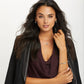 Model wearing a Brighton silver-plated pendant necklace with crystal accent and coordinating Brighton hoop earrings and bracelet