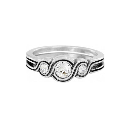 Brighton silver-plated ring with three crystals and swirling scroll detail along the band on a white background