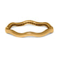 Brighton bangle bracelet with wavy gold-tone design and engraved scroll detailing along the inner edge on a white background
