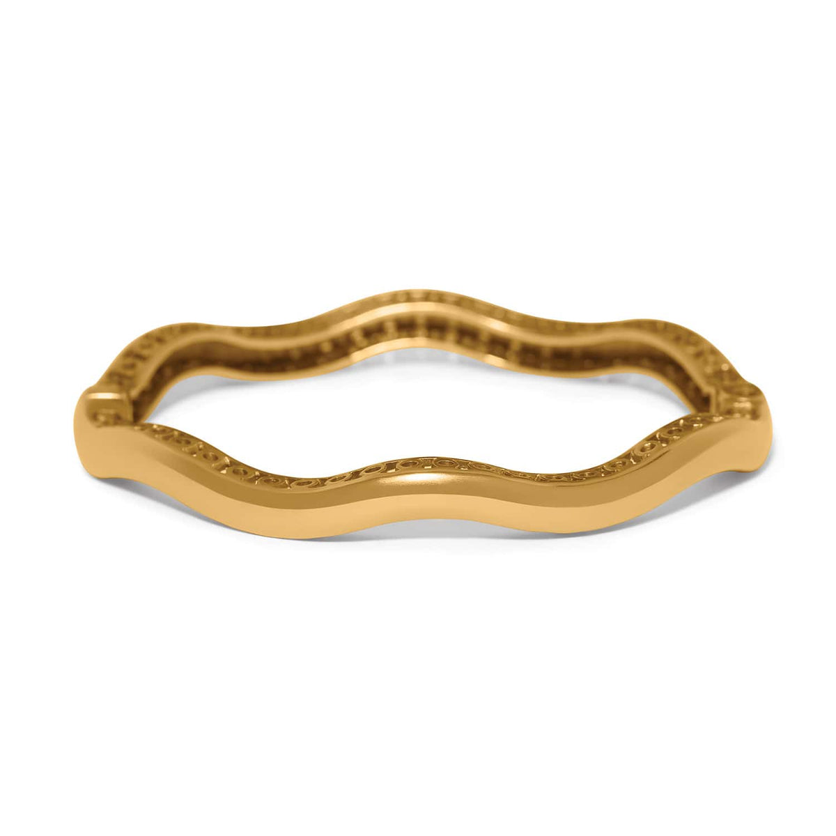 Brighton bangle bracelet with wavy gold-tone design and engraved scroll detailing along the inner edge on a white background