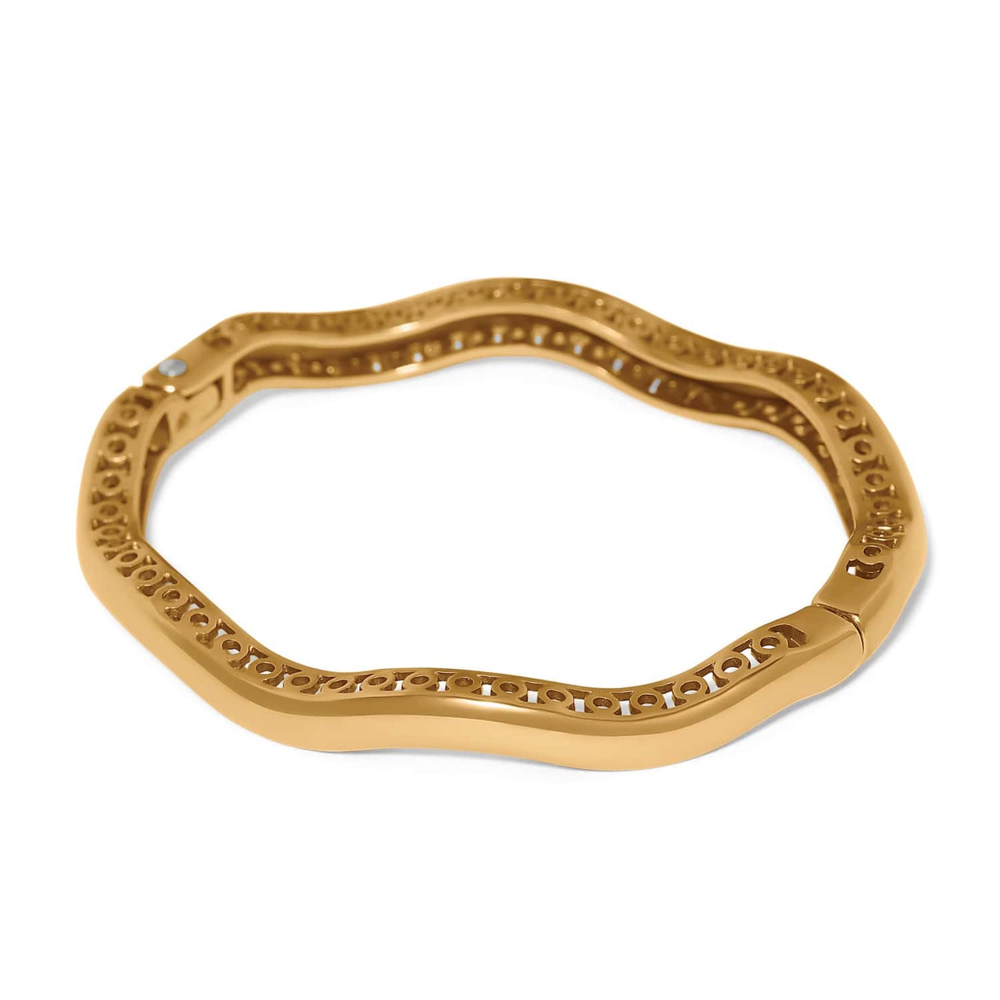 Brighton bangle bracelet shown from the back with wavy gold-tone openwork design and hinged clasp on a white background