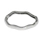 Brighton bangle bracelet shown from the back with silver-plated wavy design and openwork detailing on a white background
