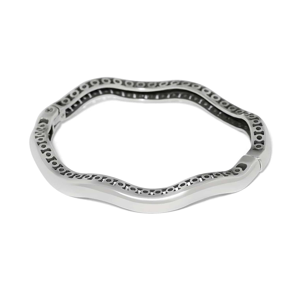 Brighton bangle bracelet shown from the back with silver-plated wavy design and openwork detailing on a white background