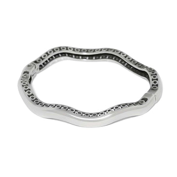 Brighton bangle bracelet shown from the back with silver-plated wavy design and openwork detailing on a white background
