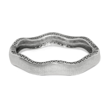 Brighton bangle bracelet with wavy silver-plated design, textured finish, and openwork edge detail on a white background