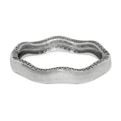 Brighton bangle bracelet with wavy silver-plated design, textured finish, and openwork edge detail on a white background