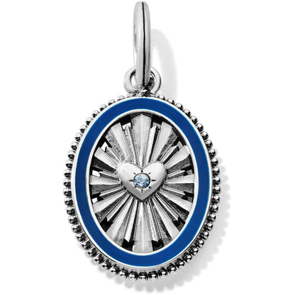 Brighton oval charm pendant with silver-plated sunburst design, central heart with crystal, and blue enamel border on a white background
