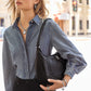 Model with a Brighton black leather shoulder handbag featuring braided strap and woven stitch detail on pebbled surface