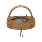 Brighton tan leather handbag shown open with braided top handle, patterned interior lining, and silver-tone knot charm on a white background