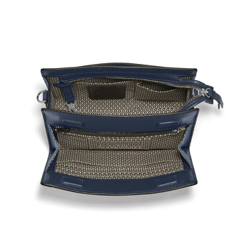 Brighton navy leather handbag shown open with patterned fabric interior, zip pocket, and silver-tone hardware on a white background