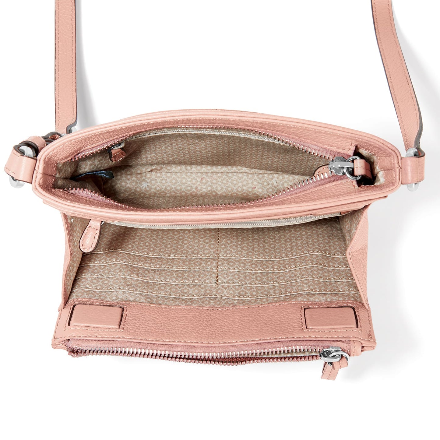 Brighton pink leather crossbody handbag shown open with patterned interior lining and adjustable strap on a white background