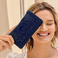 Model with a Brighton navy blue wallet featuring embroidered floral scroll design and textured leather finish
