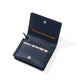 Brighton navy leather wallet shown open with card slots, floral-print interior accent, and snap closure on a white background