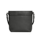 Brighton handbag shown from the back in black pebbled leather with braided shoulder strap on a white background