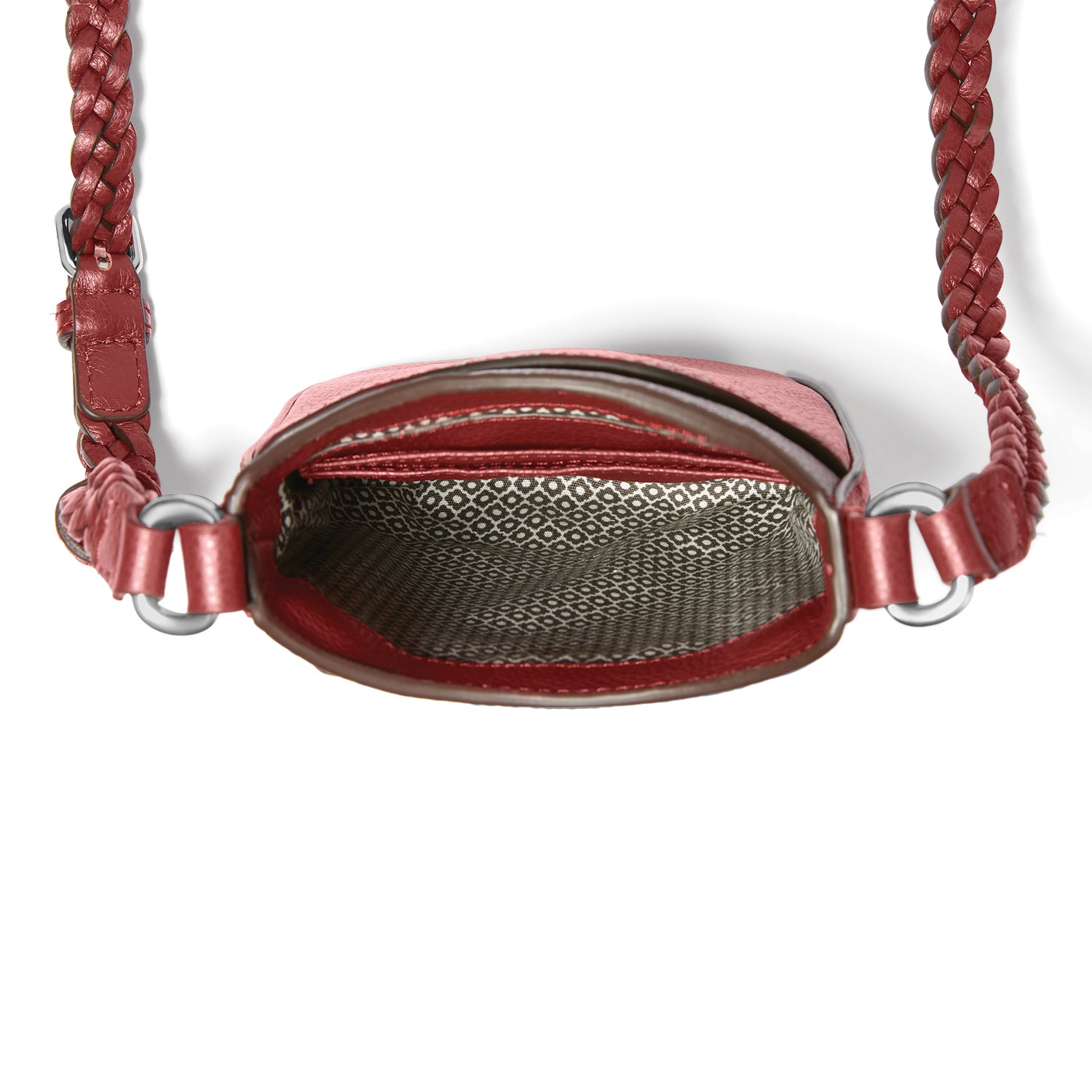 Close-up of Brighton red leather handbag interior view with patterned fabric lining and braided crossbody strap