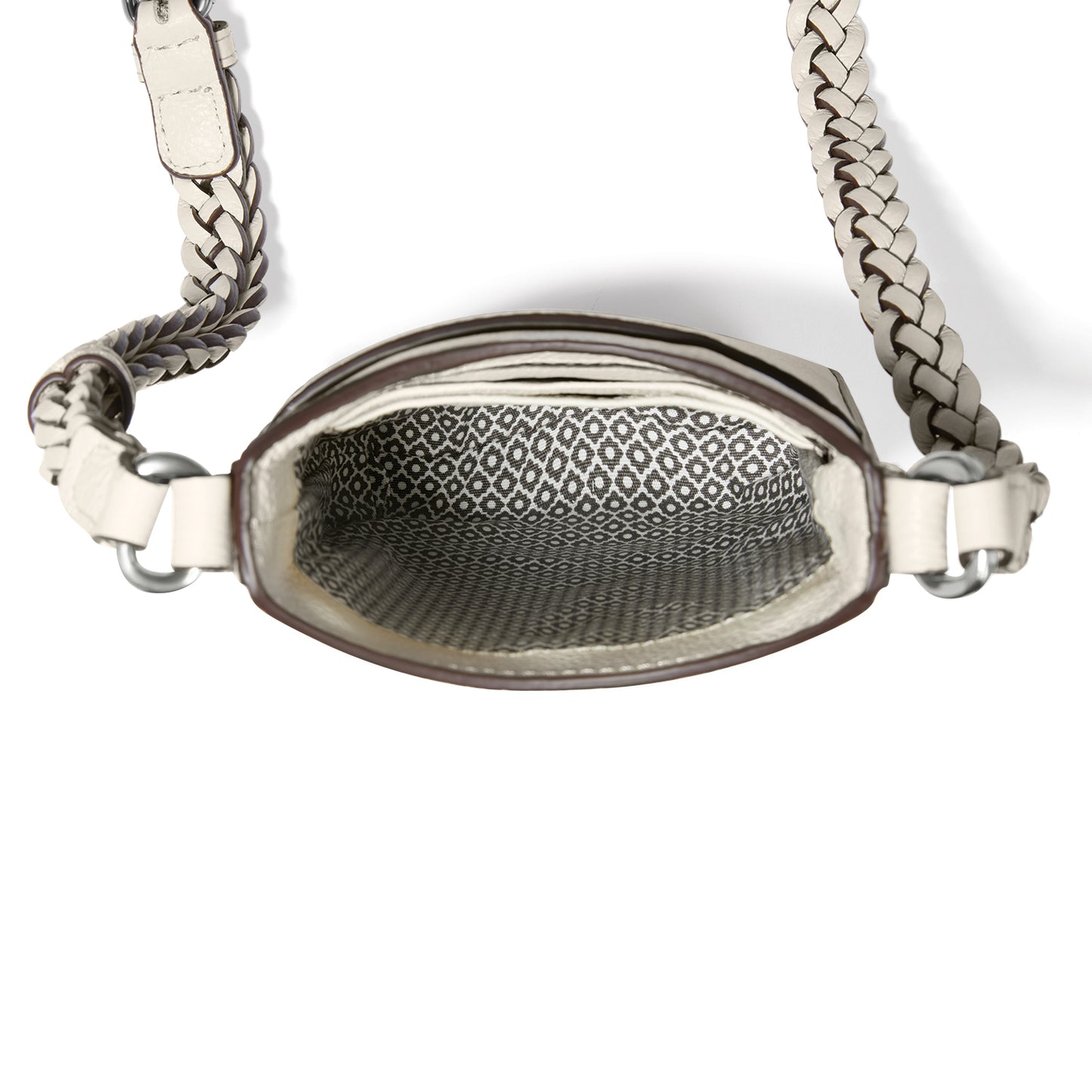 Close-up of Brighton handbag interior showing patterned fabric lining and braided cream leather crossbody strap