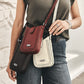 Model with Brighton crossbody handbags in burgundy, black, and cream leather with braided trim and silver-tone accents
