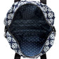 Close-up of Brighton backpack interior view showing navy polka dot lining with zippered pocket and Celtic knot exterior print