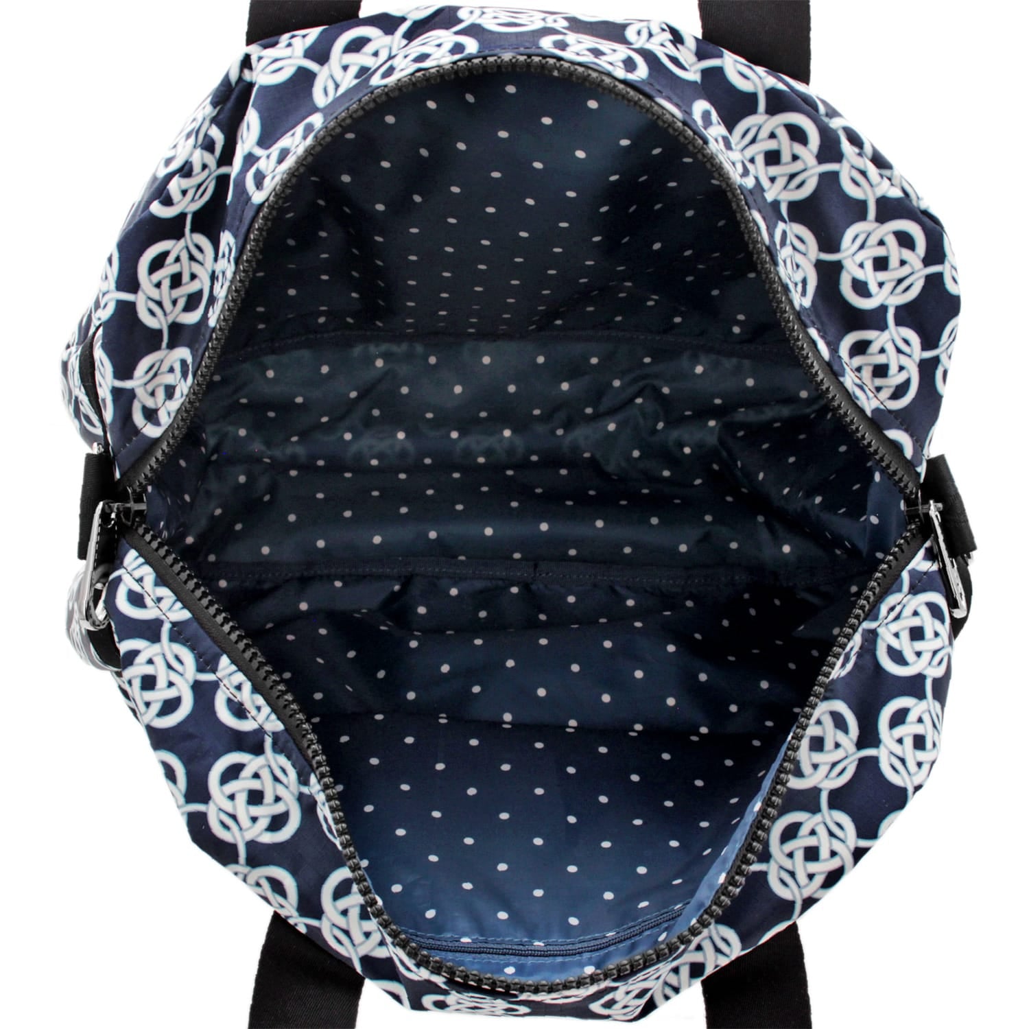 Close-up of Brighton backpack interior view showing navy polka dot lining with zippered pocket and Celtic knot exterior print