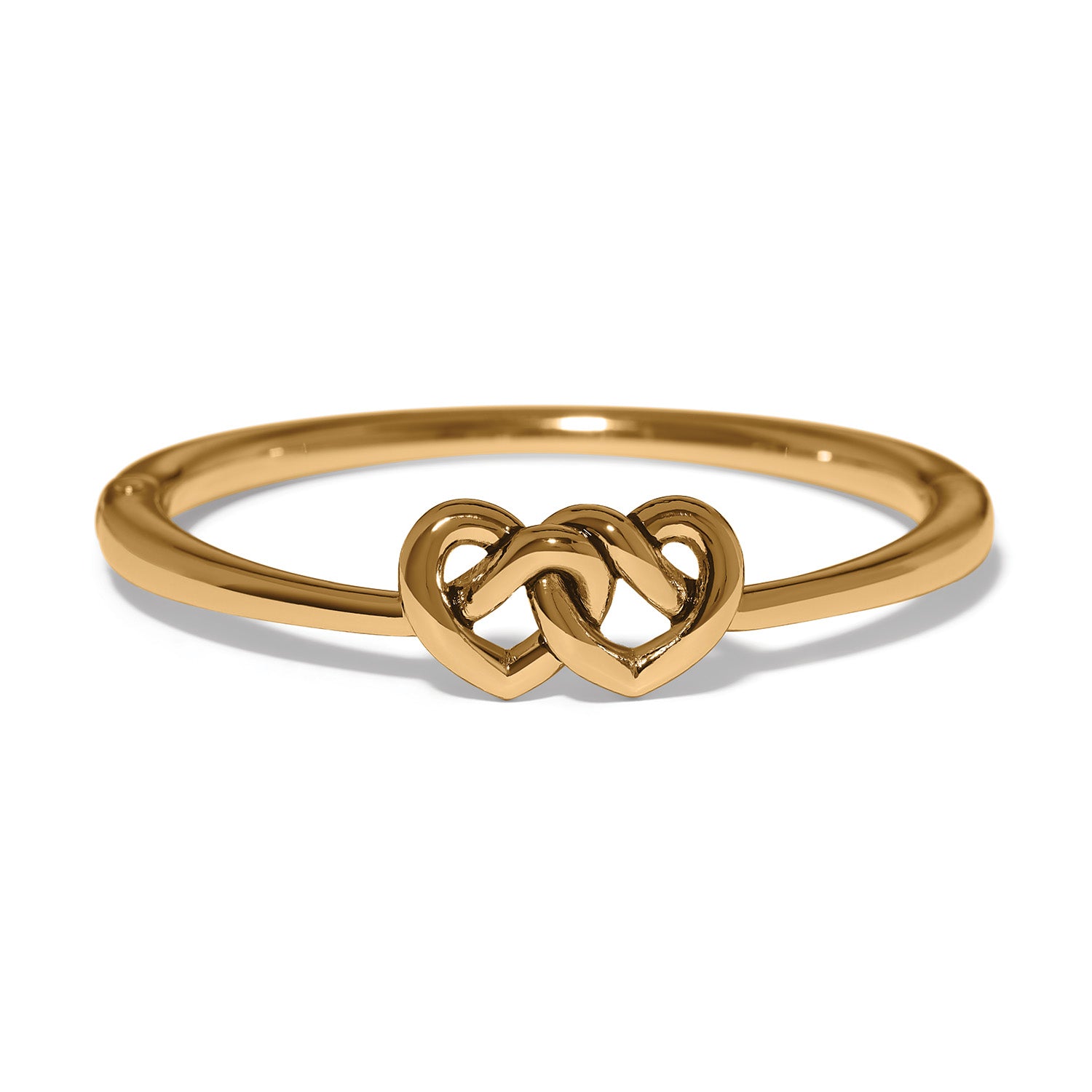 Brighton ring with gold-plated band and two interlocking heart motifs at the center on a white background
