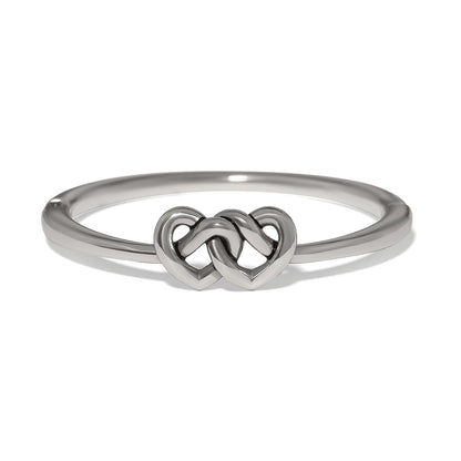 Brighton ring with silver-plated band featuring two interlocking heart motifs at the center on a white background