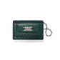 Brighton green pebbled leather wallet with silver-tone knot emblem, woven trim, and chain wristlet on a white background