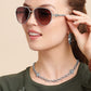 Model wearing Brighton silver-plated aviator sunglasses with gradient lenses and coordinating Brighton accessories including hoop earrings and chain necklace