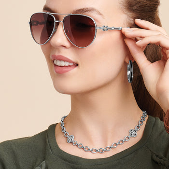 Model wearing Brighton silver-plated aviator sunglasses with gradient lenses and coordinating Brighton accessories including hoop earrings and chain necklace