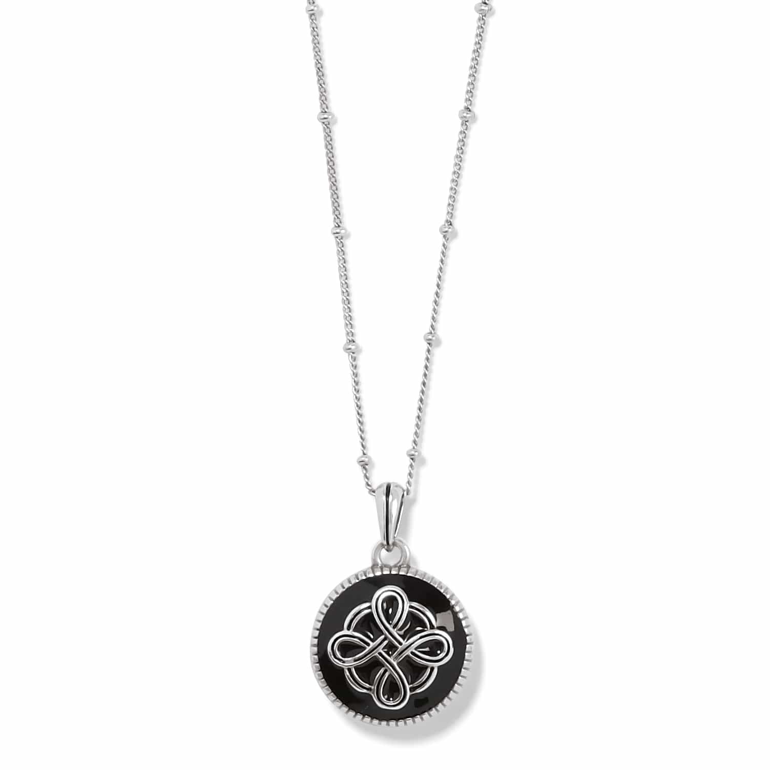 Brighton pendant necklace with black enamel disc, silver-plated Celtic knot design, and beaded chain on a white background