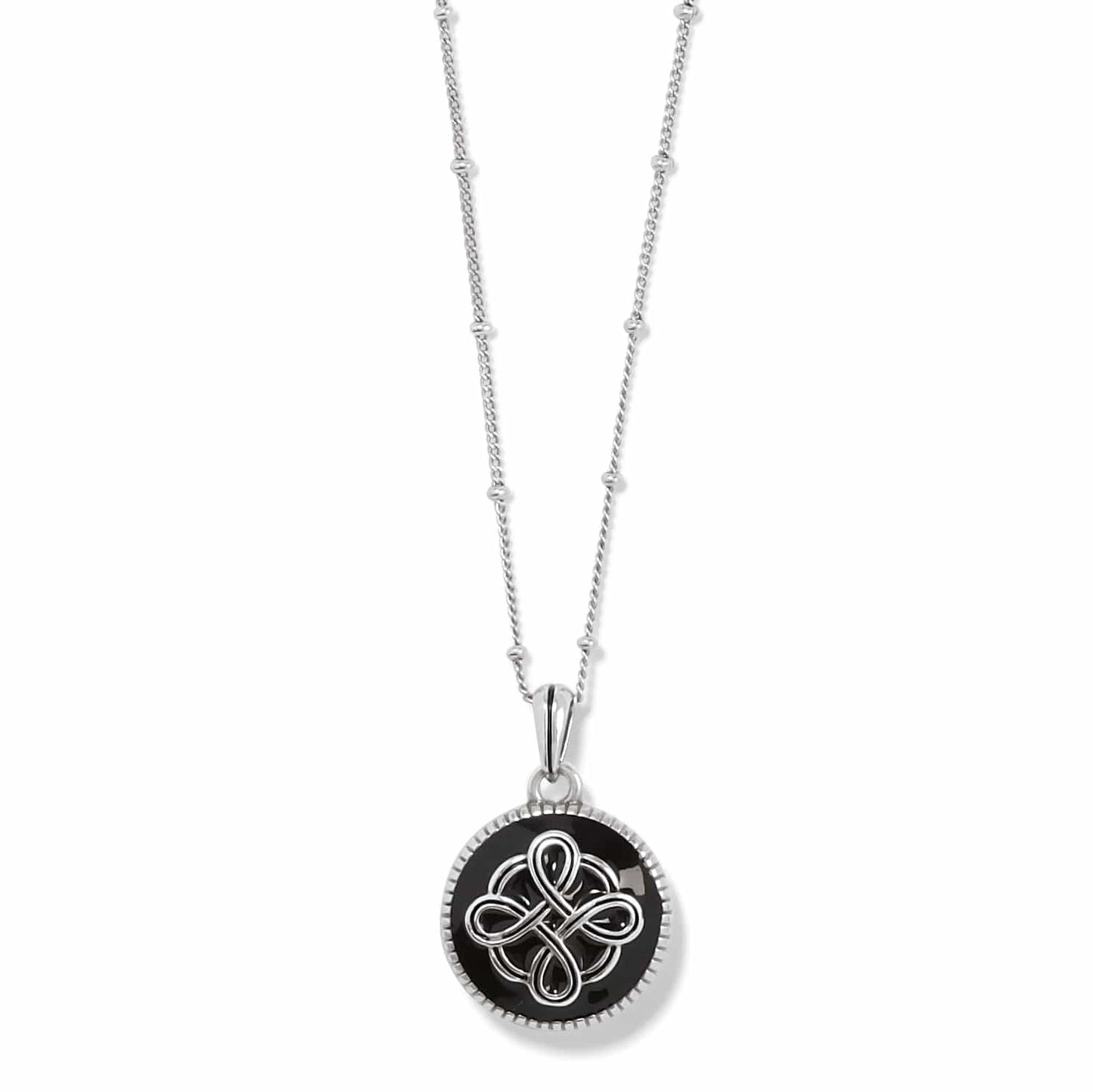 Brighton pendant necklace with black enamel disc, silver-plated Celtic knot design, and beaded chain on a white background