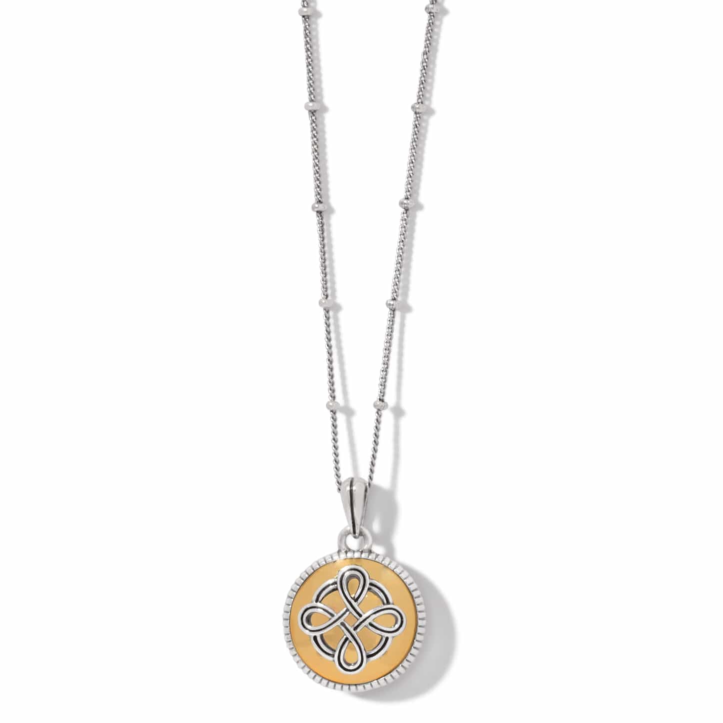 Brighton pendant necklace with silver-plated Celtic knot on gold medallion and beaded chain on a white background