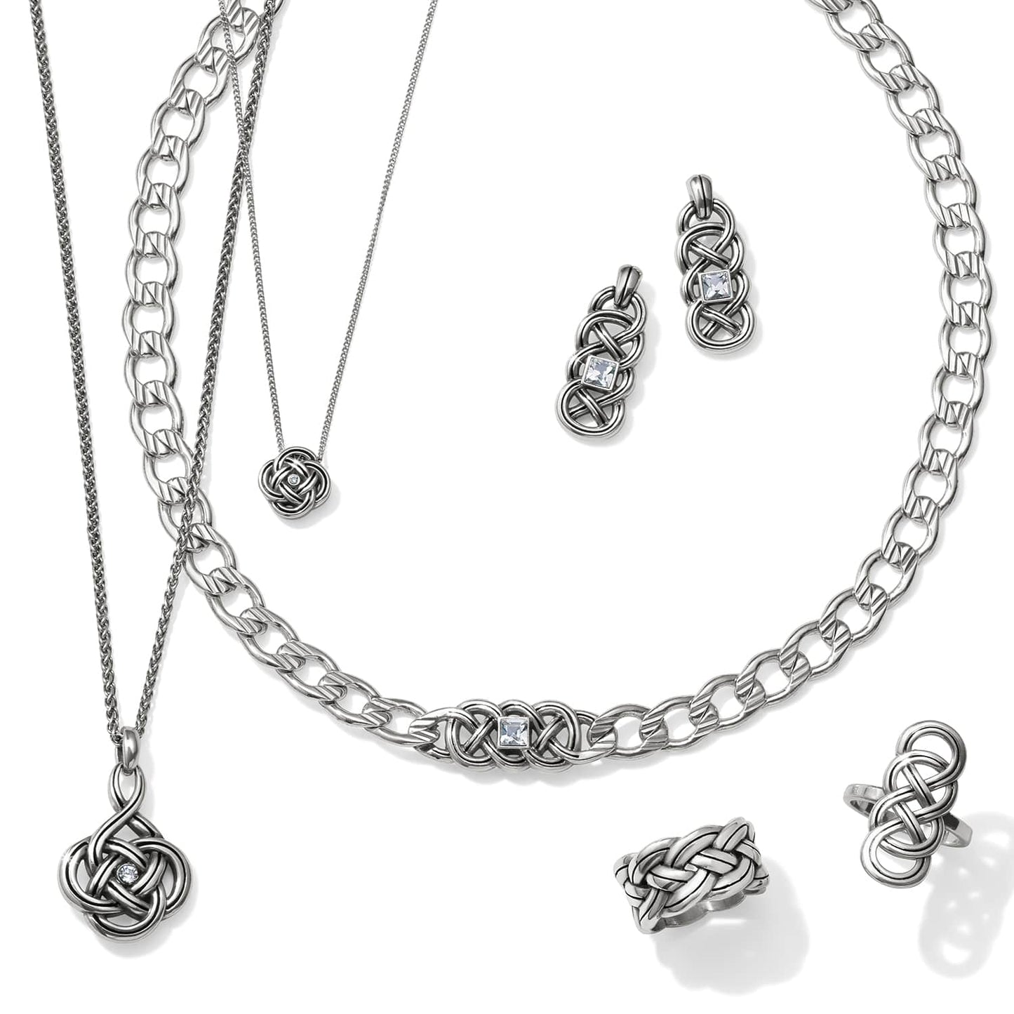 Brighton silver-plated jewelry set styled with matching Celtic knot necklaces, earrings, and rings on a white background