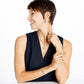 Model wearing a Brighton silver-plated knot pendant necklace with coordinating Brighton earrings, ring, and bracelet accessories