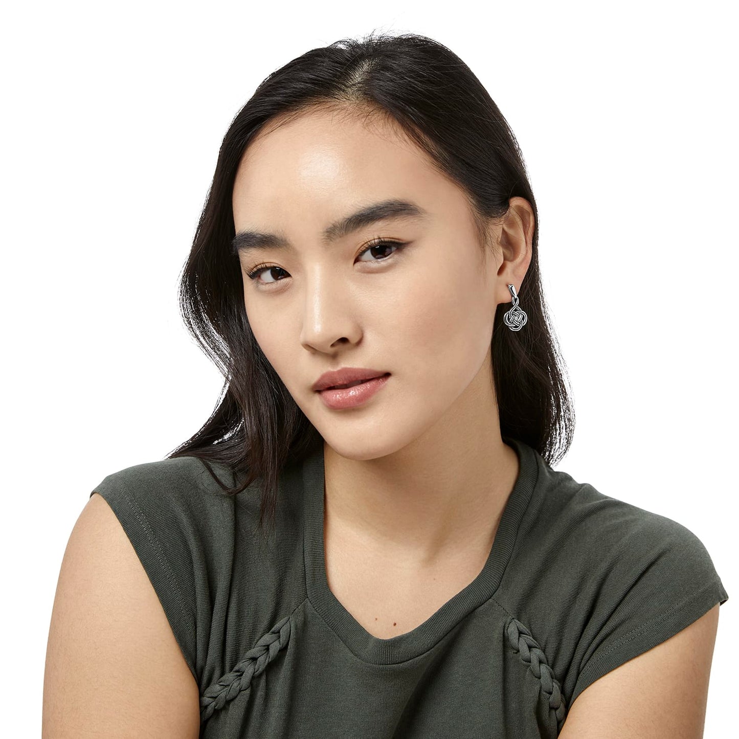 Model wearing Brighton silver-plated drop earrings with intricate Celtic knot design and polished finish