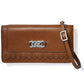 Brighton brown leather wallet with silver-tone Celtic knot emblem, zigzag stitching detail, and wristlet strap on a white background