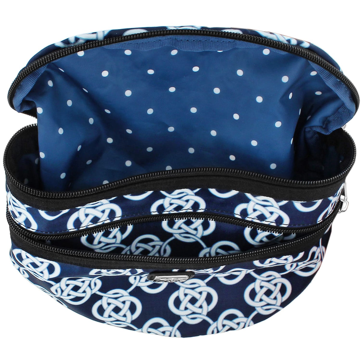 Brighton cosmetic bag shown open with navy Celtic knot print exterior and polka dot interior lining on a white background